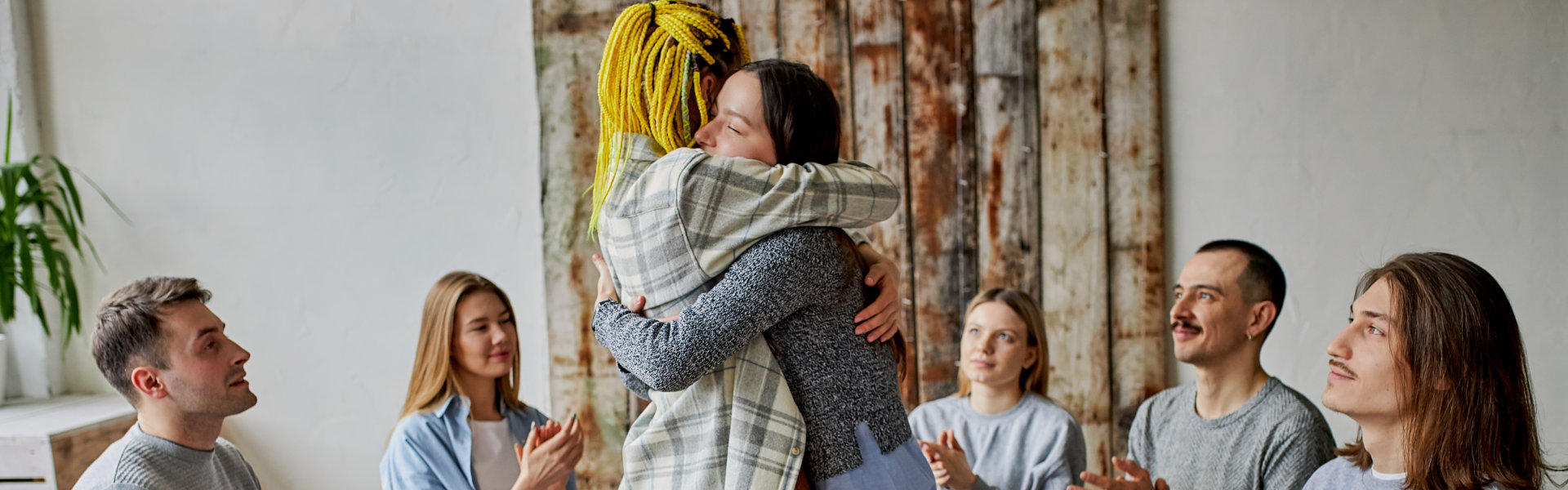 two people hugging each other in the center of the crowd