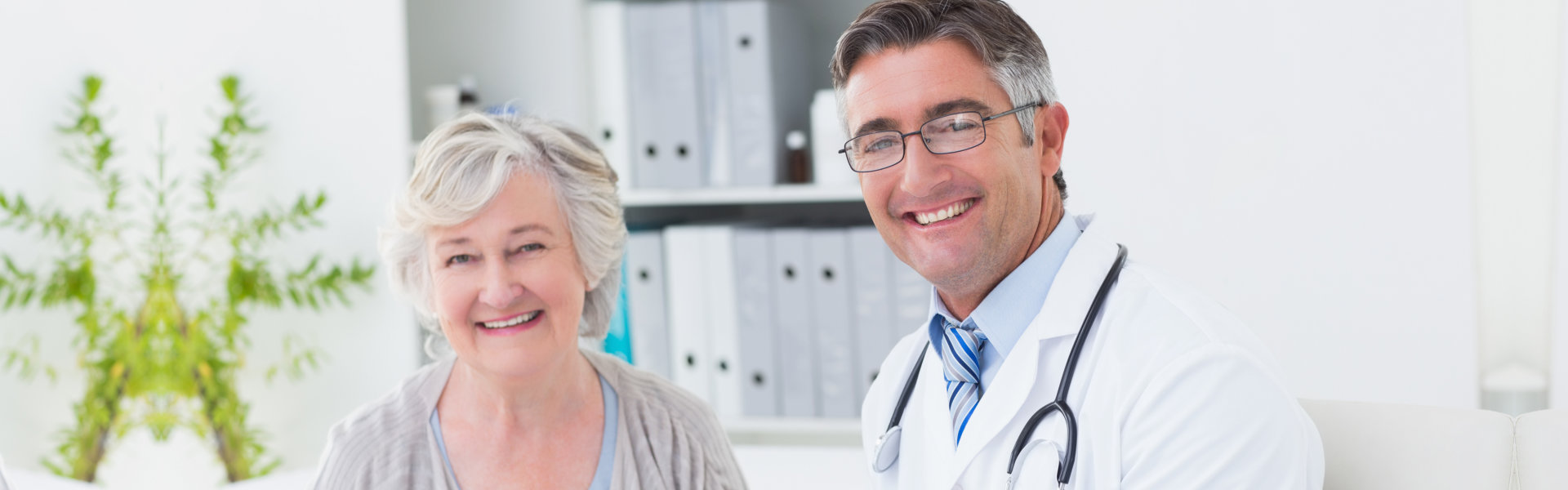 ederly woman and a doctor smiling together